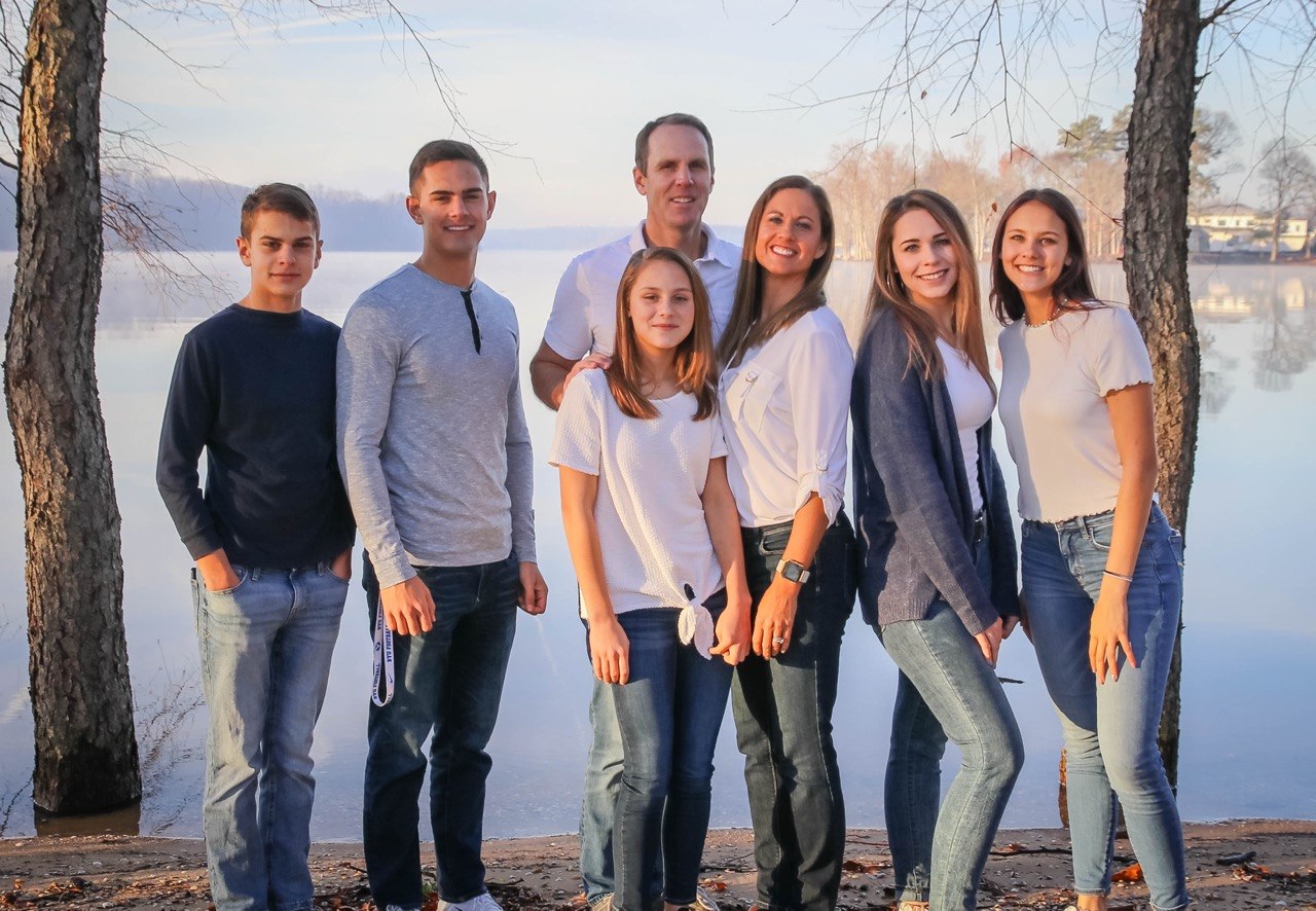 The family that started RallyRank.club, standing together by a lake.